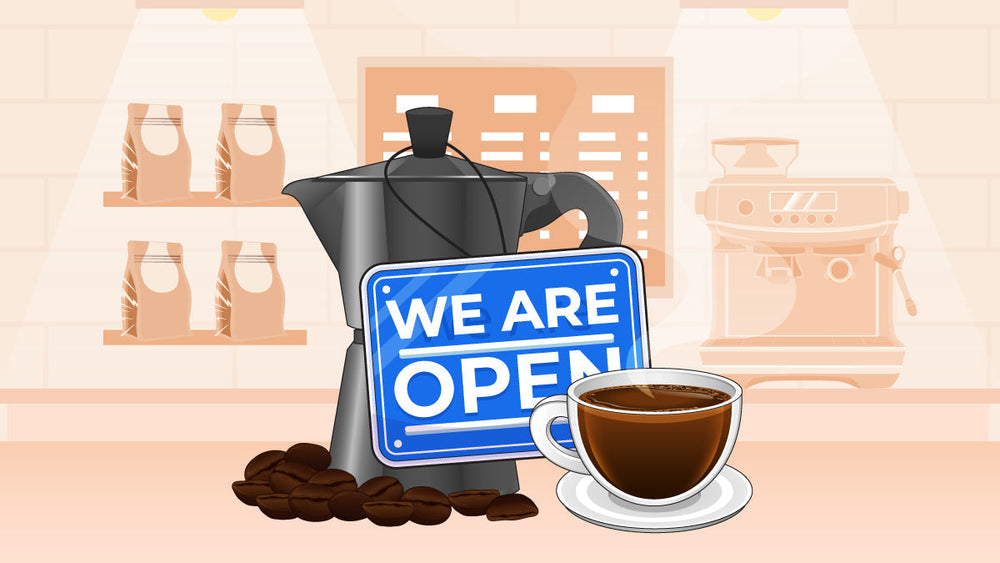 Blue “We Are Open” sign in front of a moka pot, coffee cup, coffee beans, and shelves in a cozy café.