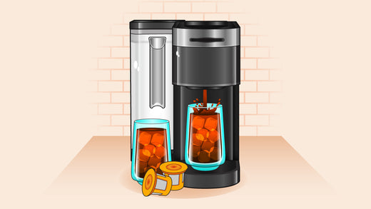 Coffee machine brewing iced coffee into a glass filled with ice cubes, with another glass of iced coffee and two coffee pods