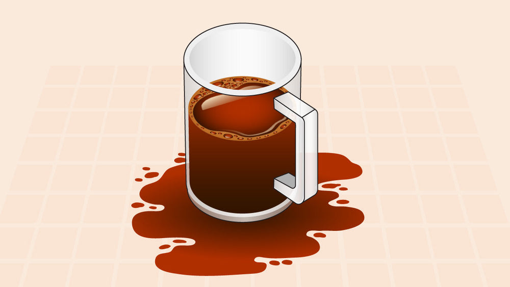 Transparent coffee mug filled with coffee, surrounded by a spilled coffee puddle