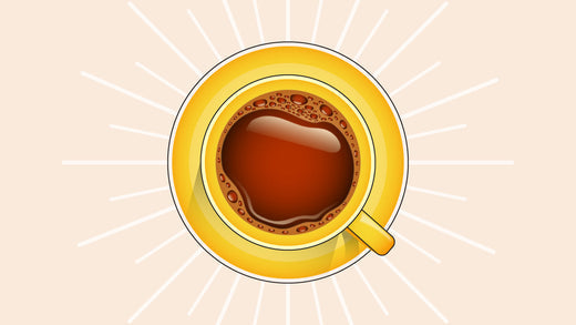 Top-down view of black coffee in a yellow cup with radiant white rays