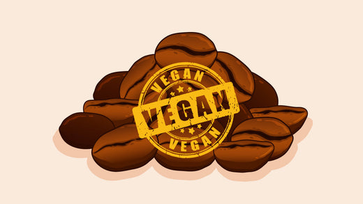 Pile of roasted coffee beans with a yellow 'Vegan' stamp