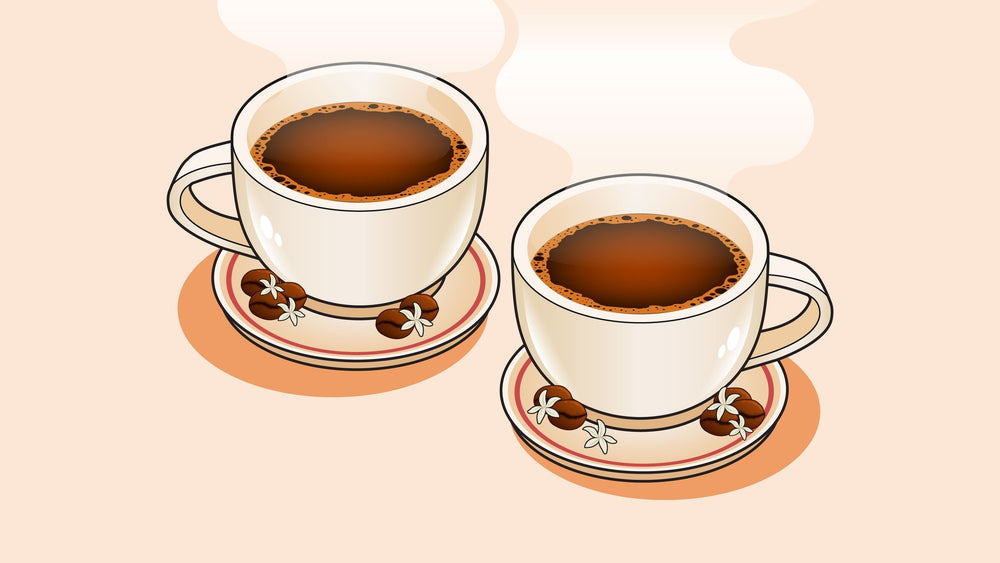 Two steaming coffee cups on saucers