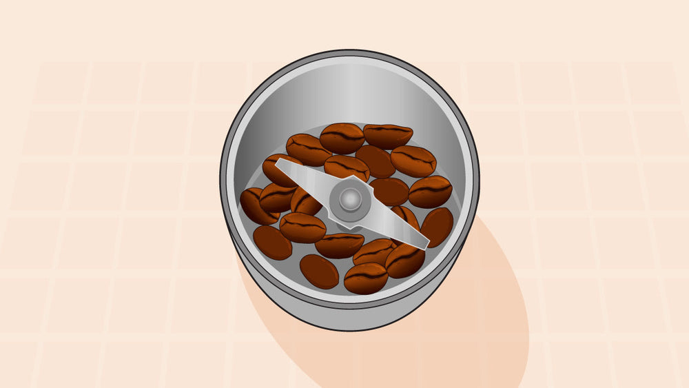 Top view of a coffee grinder with whole coffee beans and a central metal blade