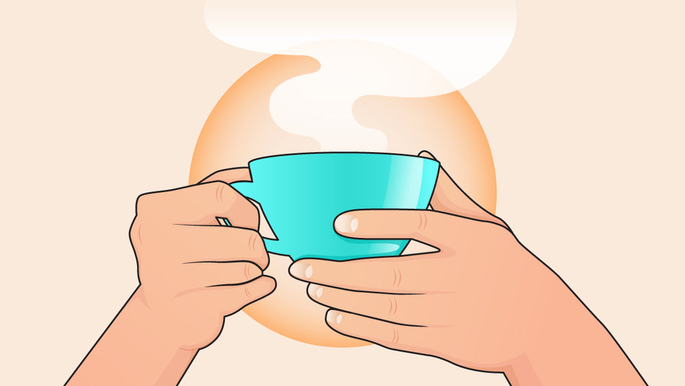 Holding a fresh cup of coffee in a blue cup.