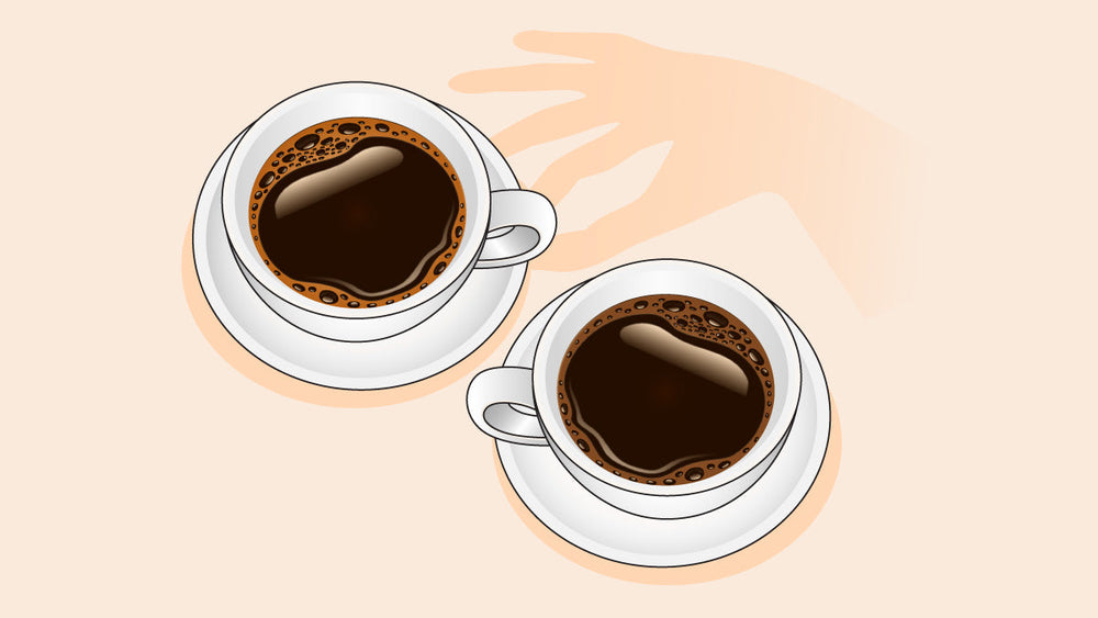 Two cups of hot black coffee on saucers with a hand shadow reaching