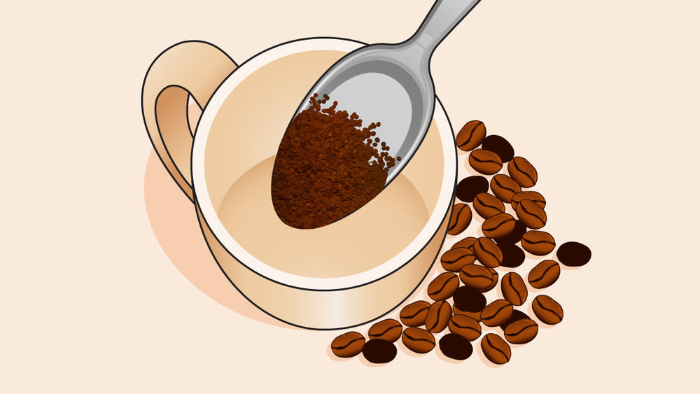 Beige mug with a spoon of instant coffee granules, surrounded by coffee beans