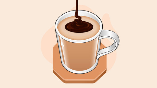 Creamy coffee in a clear mug with chocolate syrup swirl