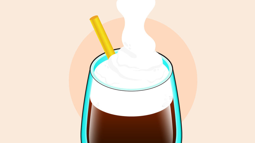 Glass of iced coffee topped with whipped cream and a yellow straw.