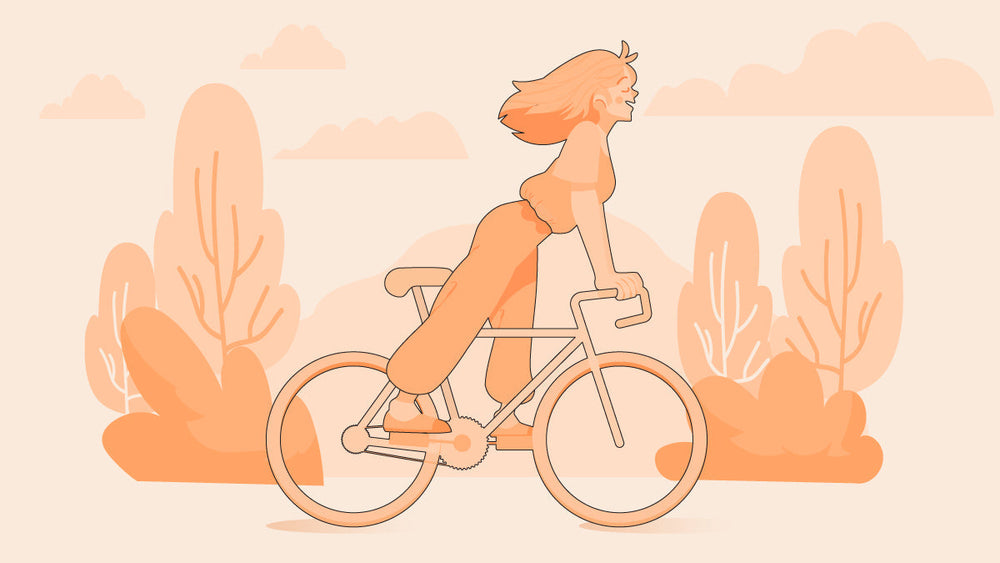 Woman riding a bicycle outdoors with trees and clouds.