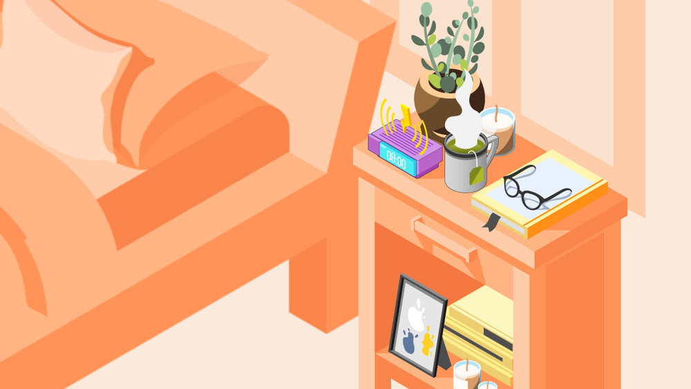 A cozy bedside table setup with a cup of hot coffee, alarm clock showing 8:00, books, glasses, plant, candle, and a framed photo.