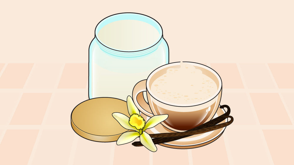 A cup of vanilla-flavored coffee with frothy milk, vanilla pods, a vanilla flower, and a milk jar