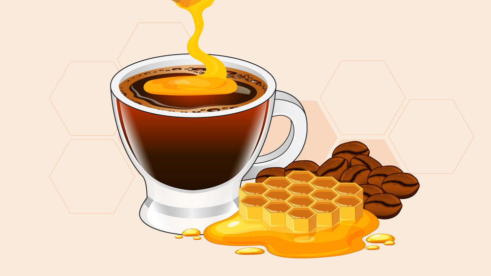 Cup of black coffee with honey being poured in, next to honeycomb and coffee beans.