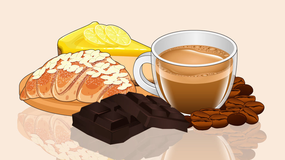 A cup of coffee surrounded by a lemon tart, almond pastry, dark chocolate, and coffee beans.