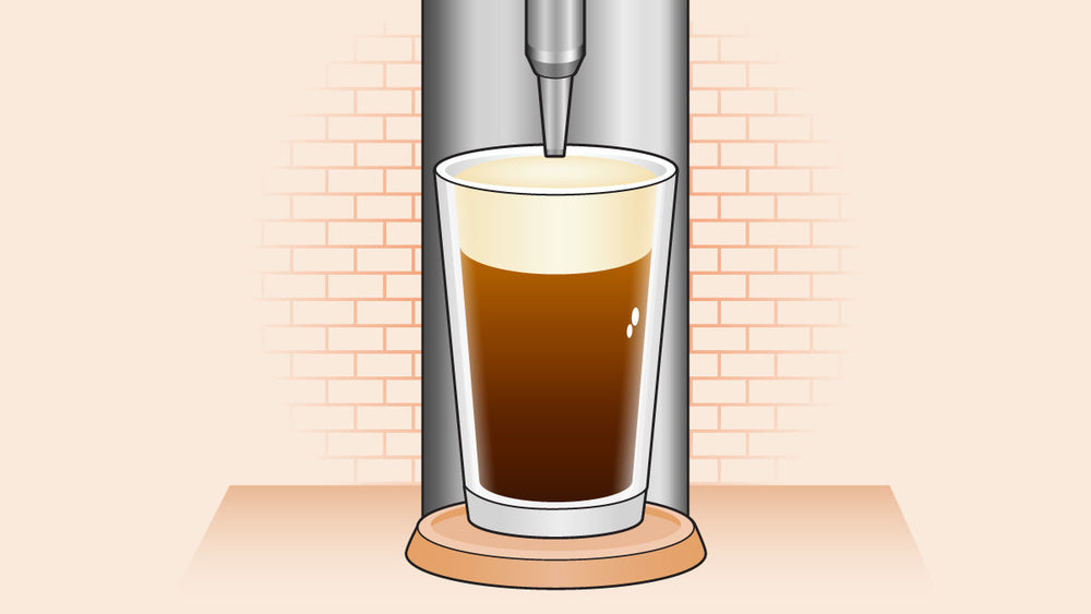 Glass of creamy brown coffee pouring from a dispenser