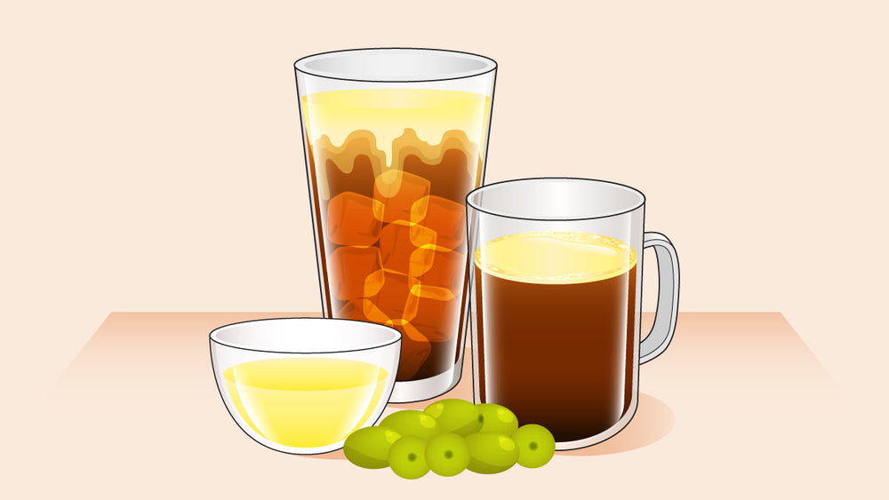 Glass of iced Oleato coffee and hot Oleato coffee, with a bowl of olive oil and fresh green olives in front.