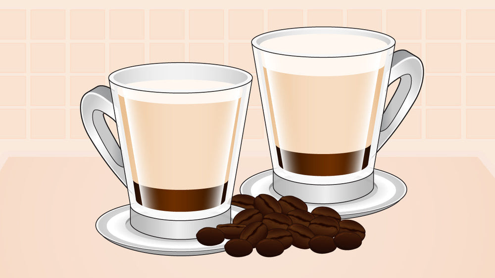 Two latte macchiatos in glass mugs on saucers, with coffee beans scattered in front.