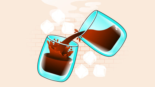 Pouring coffee into a glass with splashes and ice cubes in the background