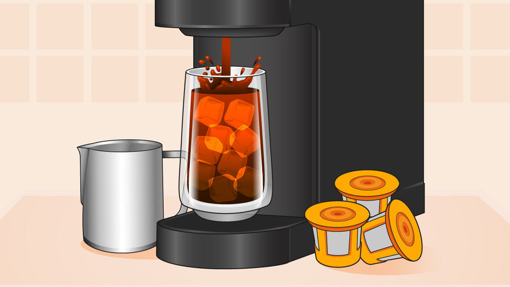 Keurig coffee maker brewing iced coffee into a tall glass with ice, beside milk frothing pitcher and coffee pods.