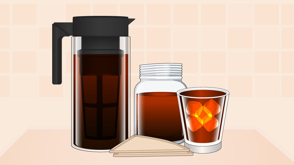 Cold brew setup with a tall coffee pitcher, jar of concentrate, paper filters, and a glass of iced coffee.