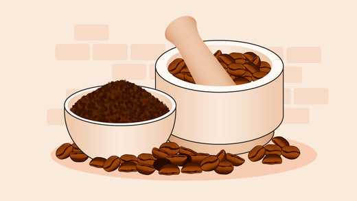 Mortar and pestle with coffee beans and ground coffee in a bowl