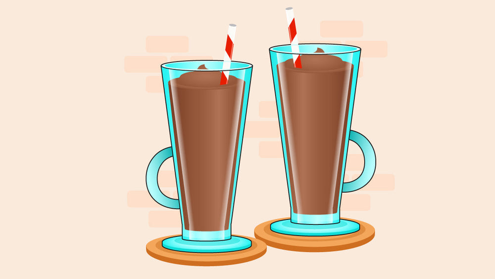 Two tall glasses of chocolate coffee smoothies with straws on wooden coasters