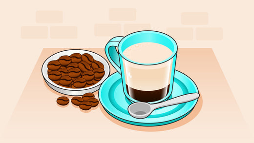 Coffee with cream in a blue cup and saucer, served with a plate of coffee beans