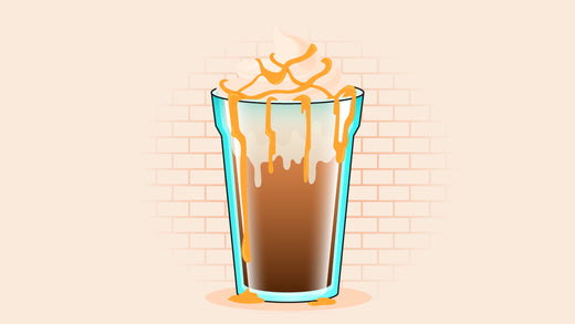 a tall glass of iced coffee topped with whipped cream and caramel drizzle