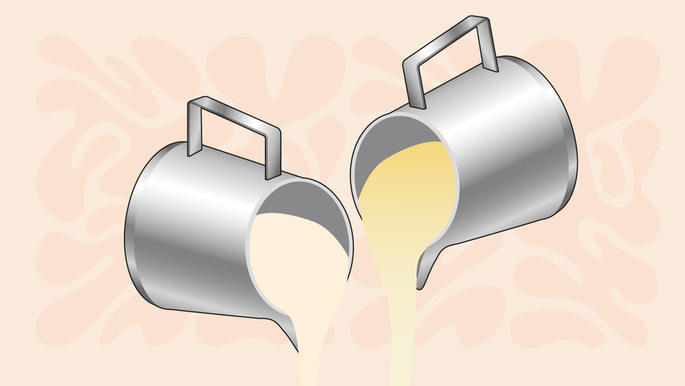 Two metal pitchers pouring cream and coffee creamer in light beige and yellow tones.