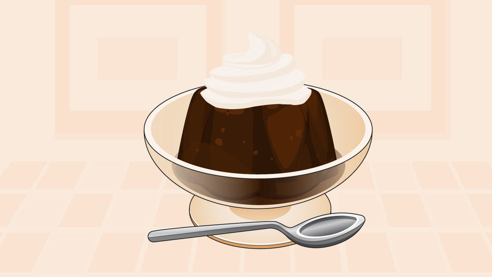 A coffee jelly dessert topped with whipped cream in a glass bowl, served with a silver spoon