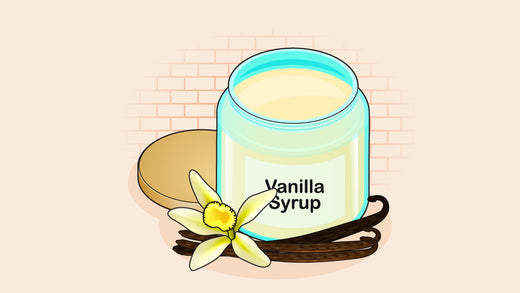 A jar of vanilla syrup with a vanilla flower and pods