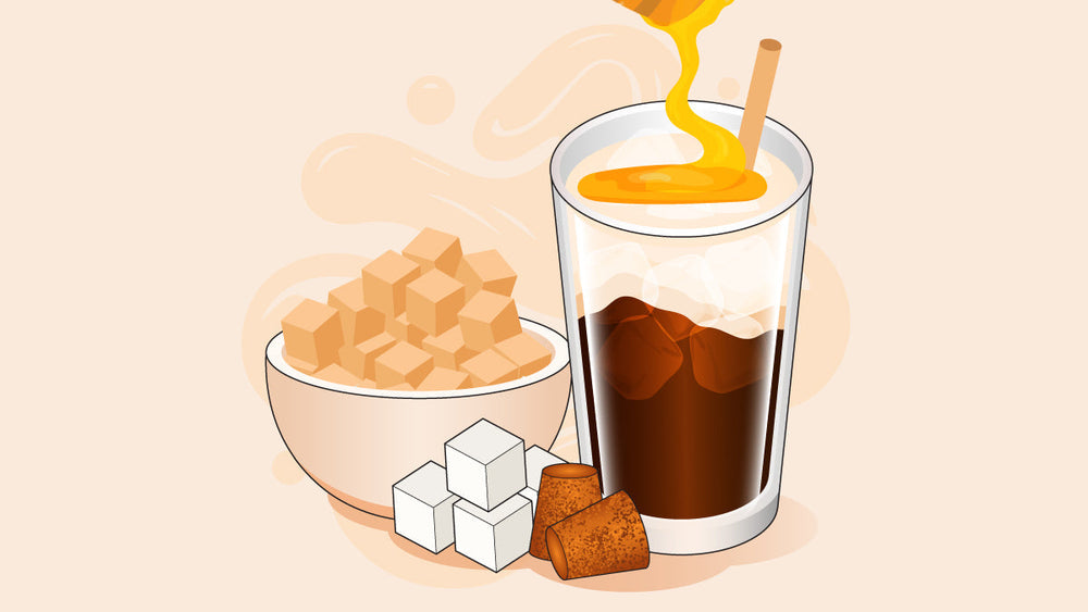 Iced coffee with honey being poured in, next to a bowl of sugar cubes and loose sugar pieces.