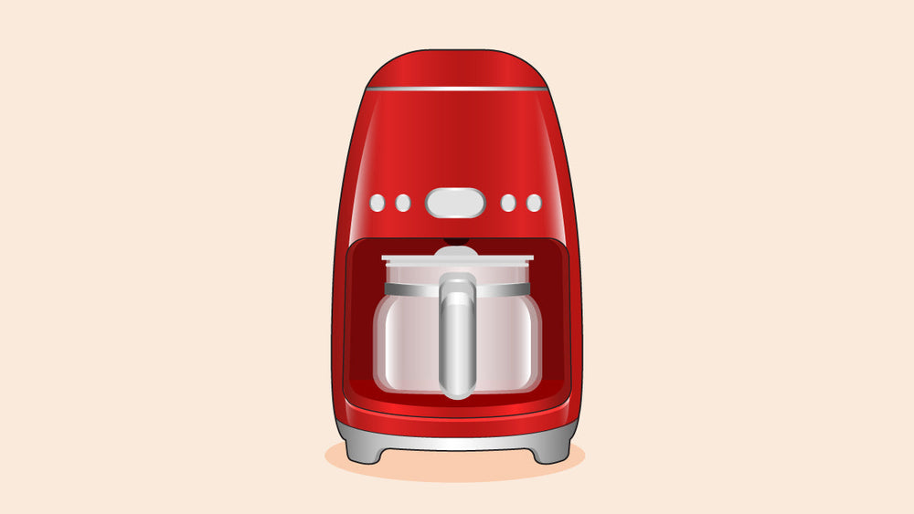 A red SMEG drip coffee maker with a glass carafe, featuring a retro design and control buttons