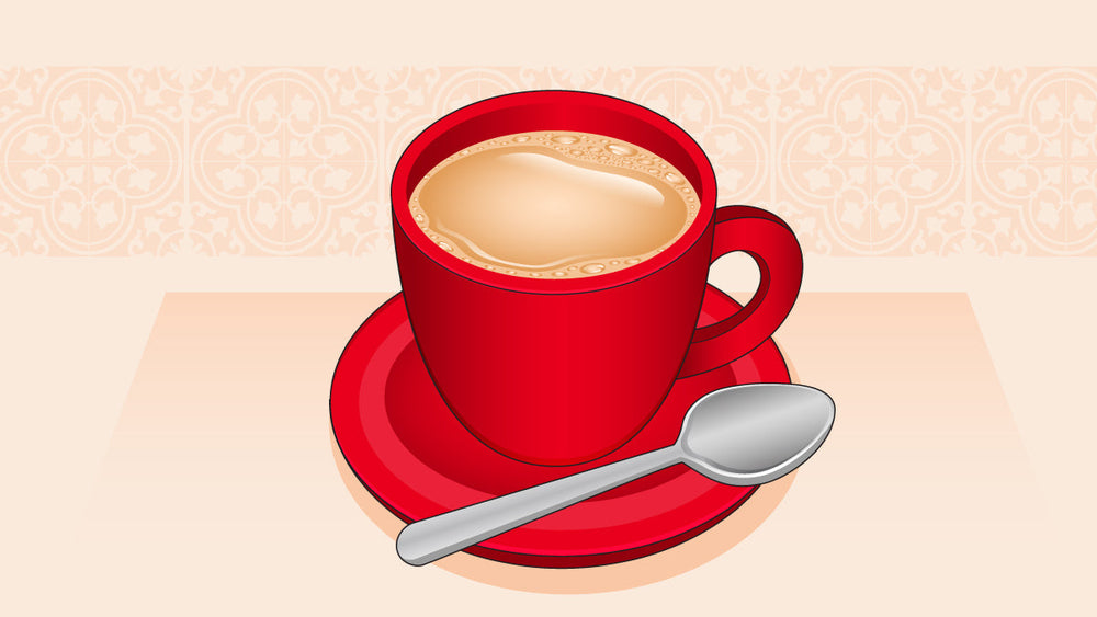 A red cup of coffee with milk on a matching saucer, accompanied by a silver spoon