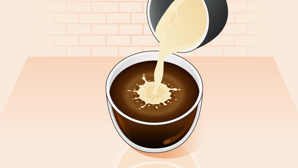Coffee creamer being poured into a cup of black coffee