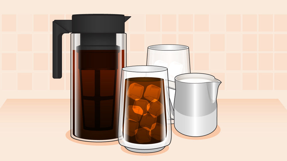 Cold brew coffee in a glass pitcher with iced coffee, milk, and an empty glass