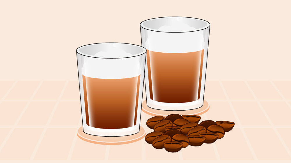 Two glasses of cold foam coffee next to a small pile of coffee beans.