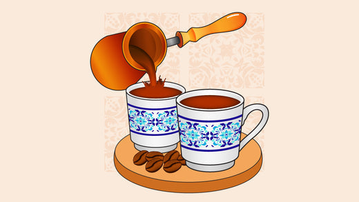 Turkish coffee being poured from a cezve into patterned cups on a wooden tray with coffee beans